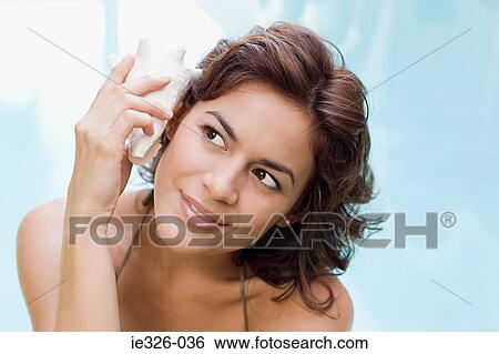 Stock Photograph - Woman with conch shell. Fotosearch