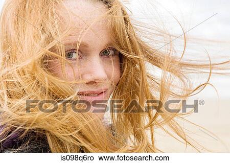 Woman with hair blowing in breeze View Large Photo Image Picture - Woman with hair blowing in breeze. Fotosearch