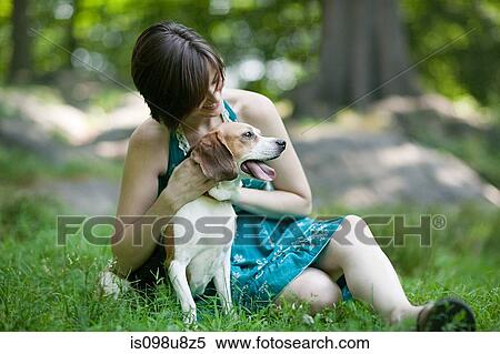 Stock Photography - Woman with her pet beagle. Fotosearch