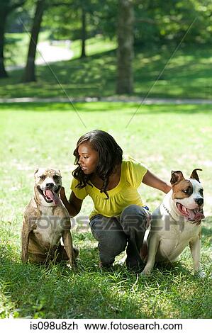 Stock Image - Woman with her two pet dogs. Fotosearch
