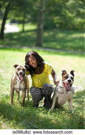 Stock Image - Woman with her two pet dogs. Fotosearch