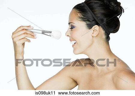 Woman with makeup brush View Large Photo Image Stock Image - Woman with makeup brush. Fotosearch