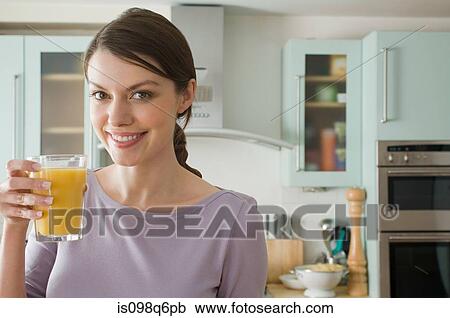 Stock Image - Woman with orange juice. Fotosearch