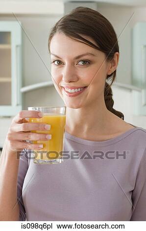 Stock Image - Woman with orange juice. Fotosearch