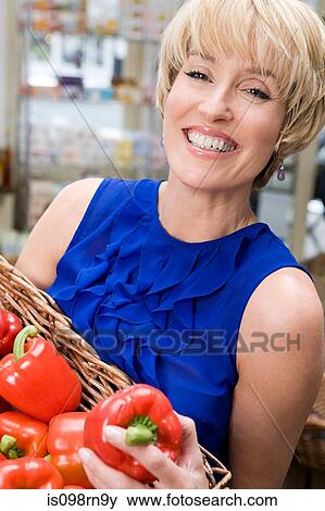 Woman with red peppers View Large Photo Image Stock Photo - Woman with red peppers. Fotosearch