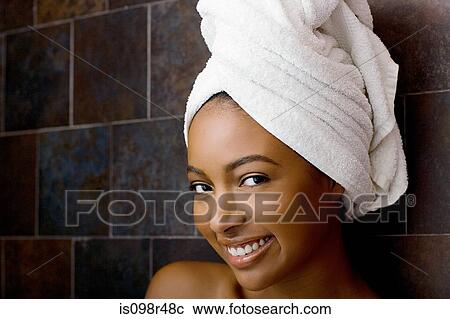 Stock Image - Woman with towel on head. Fotosearch