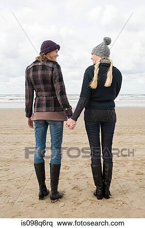 Women holding hands by the sea View Large Photo Image Stock Photography - Women holding hands by the sea. Fotosearch