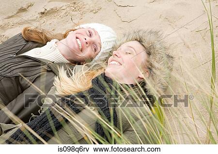 Women lying on dune View Large Photo Image Stock Photo - Women lying on dune. Fotosearch