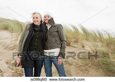 Women on sand dune View Large Photo Image Stock Image - Women on sand dune. Fotosearch