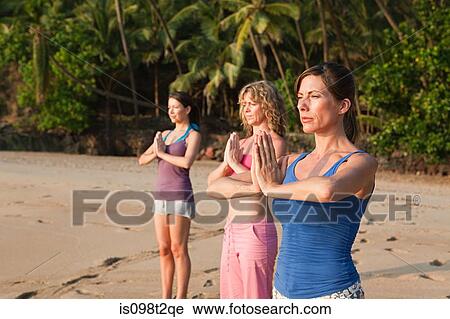 Women practicing yoga on a beach View Large Photo Image Stock Image - Women practicing yoga on a beach. Fotosearch