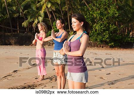 Women practicing yoga on a beach View Large Photo Image Stock Photo - Women practicing yoga on a beach. Fotosearch