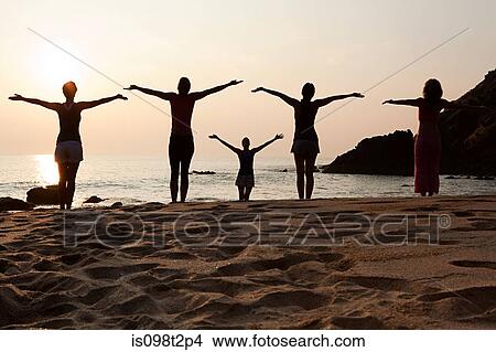 Women practicing yoga on beach at sunset View Large Photo Image Picture - Women practicing yoga on beach at sunset. Fotosearch