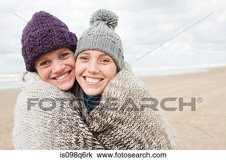Women sharing a blanket View Large Photo Image Stock Image - Women sharing a blanket. Fotosearch