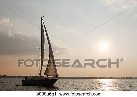 Yacht sailing on sea at dusk View Large Photo Image Stock Image - Yacht sailing on sea at dusk. Fotosearch