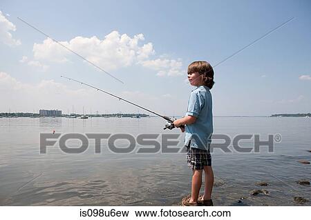 Young boy fishing on beach View Large Photo Image Stock Photo - Young boy fishing on beach. Fotosearch