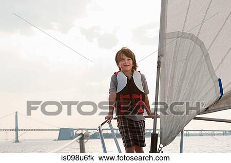 Young boy on board yacht View Large Photo Image Stock Image - Young boy on board yacht. Fotosearch