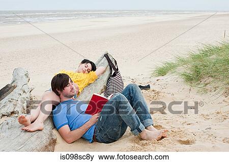 Young couple at the beach View Large Photo Image Stock Photo - Young couple at the beach. Fotosearch