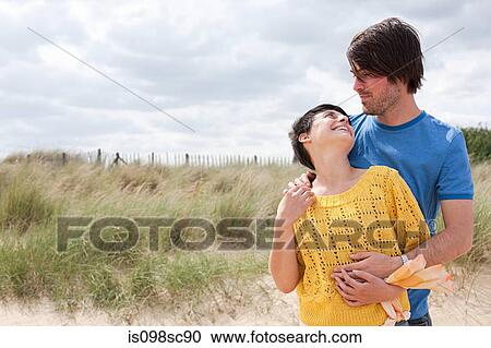 Stock Image - Young couple at the coast. Fotosearch