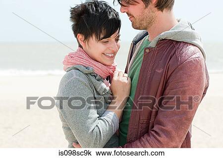 Young couple at the coast View Large Photo Image Stock Image - Young couple at the coast. Fotosearch