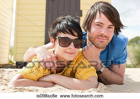 Young couple by beach hut View Large Photo Image Stock Image - Young couple by beach hut. Fotosearch