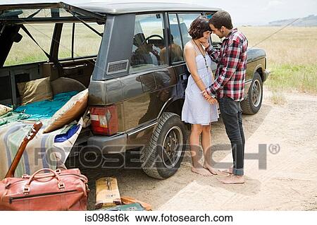 Young couple by suv View Large Photo Image Stock Image - Young couple by suv. Fotosearch
