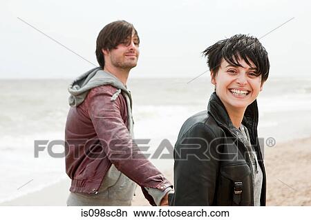 Young couple by the sea View Large Photo Image Picture - Young couple by the sea. Fotosearch