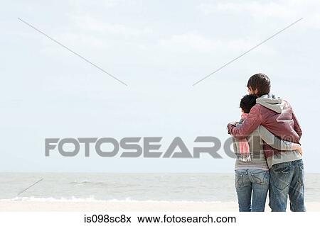 Stock Photo - Young couple by the sea. Fotosearch
