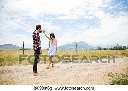 Young couple dancing in remote setting View Large Photo Image Stock Image - Young couple dancing in remote setting. Fotosearch