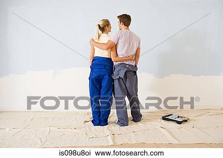 Stock Image - Young couple decorating. Fotosearch