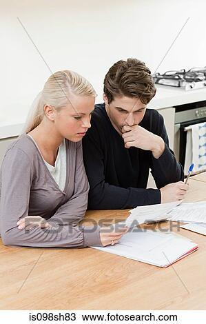 Young couple doing home finances View Large Photo Image Stock Image - Young couple doing home finances. Fotosearch