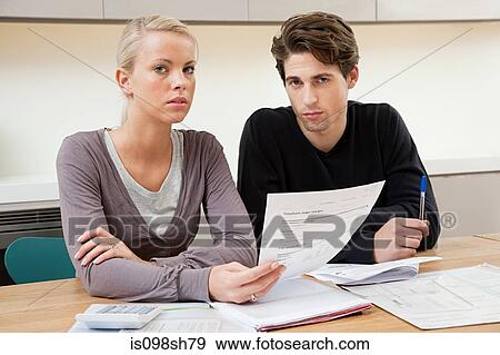Young couple doing home finances View Large Photo Image Stock Photo - Young couple doing home finances. Fotosearch