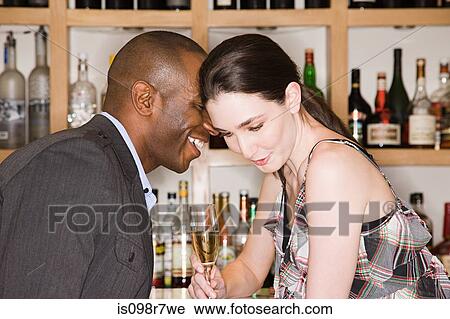 Young couple in a bar View Large Photo Image Stock Image - Young couple in a bar. Fotosearch
