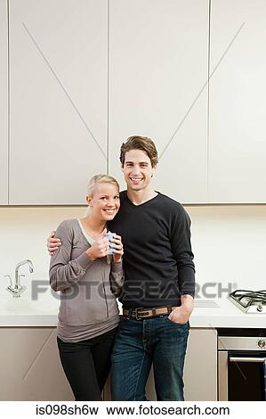 Young couple in kitchen View Large Photo Image Stock Photo - Young couple in kitchen. Fotosearch