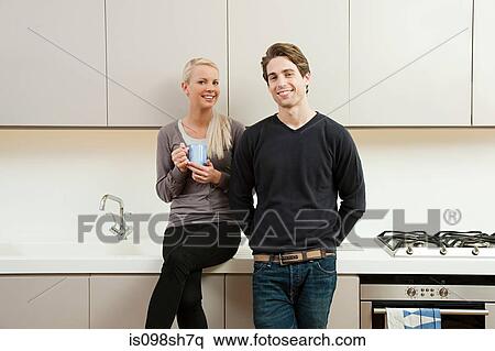 Young couple in kitchen View Large Photo Image Stock Photography - Young couple in kitchen. Fotosearch