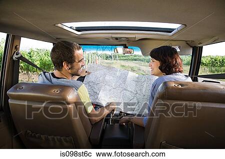 Young couple in vehicle with map View Large Photo Image Stock Image - Young couple in vehicle with map. Fotosearch
