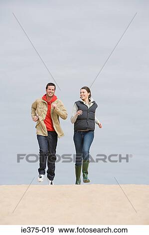 Young couple jogging on beach View Large Photo Image Stock Photo - Young couple jogging on beach. Fotosearch
