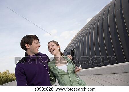 Young couple listening to music View Large Photo Image Stock Photo - Young couple listening to music. Fotosearch