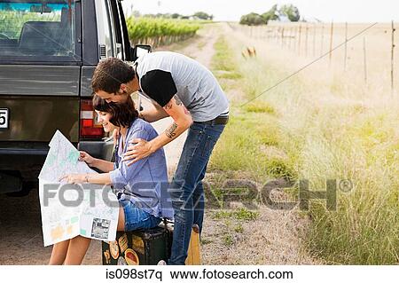 Stock Photography - Young couple looking at map. Fotosearch