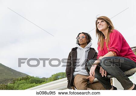 Young couple looking away View Large Photo Image Stock Photography - Young couple looking away. Fotosearch