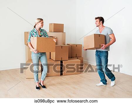 Young couple moving boxes View Large Photo Image Stock Image - Young couple moving boxes. Fotosearch
