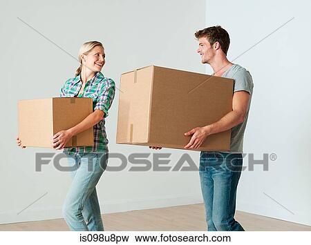 Stock Photo - Young couple moving boxes. Fotosearch