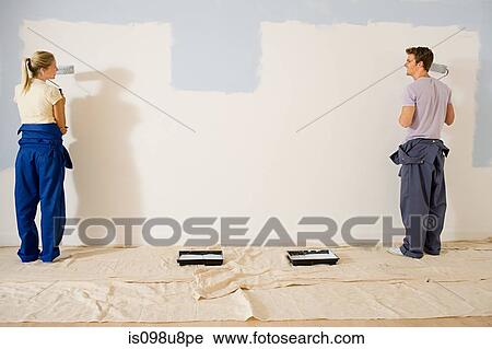 Young couple painting wall View Large Photo Image Stock Image - Young couple painting wall. Fotosearch