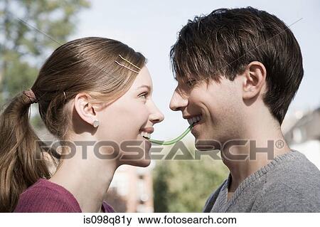 Stock Photo - Young couple sharing a sweet. Fotosearch