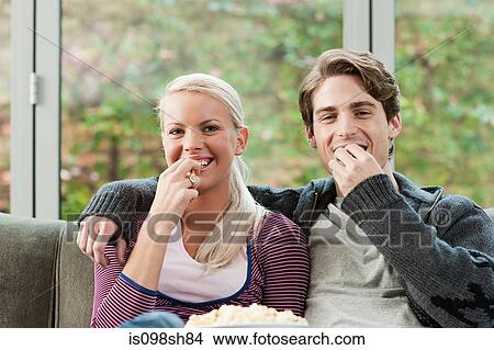Picture - Young couple watching television. Fotosearch