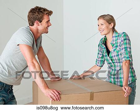 Young couple with cardboard box View Large Photo Image Stock Image - Young couple with cardboard box. Fotosearch
