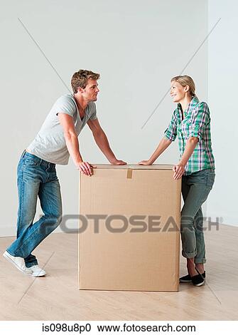 Young couple with cardboard box View Large Photo Image Stock Image - Young couple with cardboard box. Fotosearch