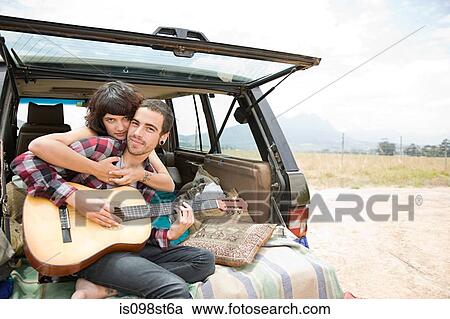 Stock Image - Young couple with guitar. Fotosearch