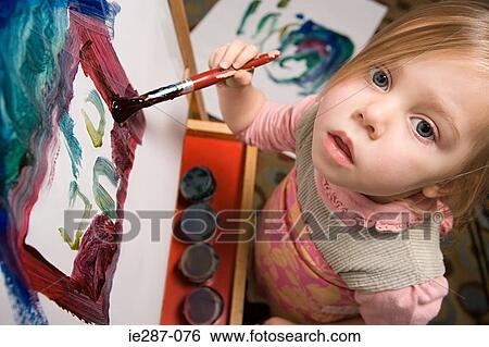 Stock Photograph - Young girl painting. Fotosearch