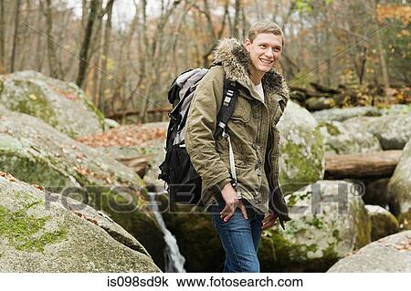 Young man amongst stones View Large Photo Image Stock Image - Young man amongst stones. Fotosearch
