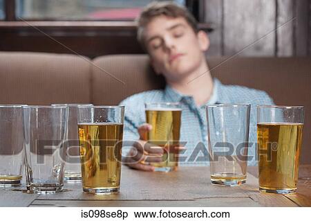 Young man asleep in bar View Large Photo Image Stock Photography - Young man asleep in bar. Fotosearch